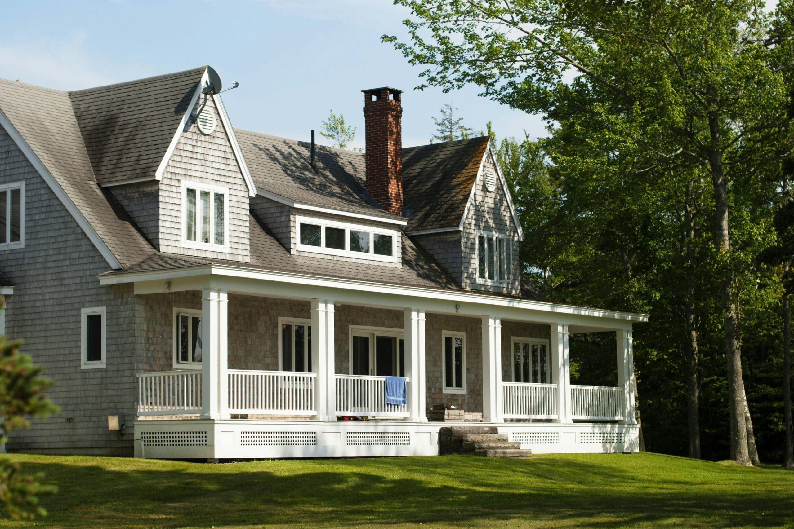 a house with a porch and a lawn